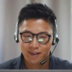 Man on computer wearing a headset